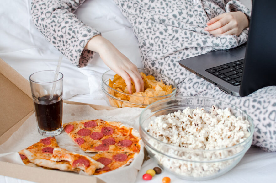 Emotional Eating image of woman surrounded by unhealthy food